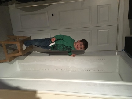 JB helping paint the basement shelves